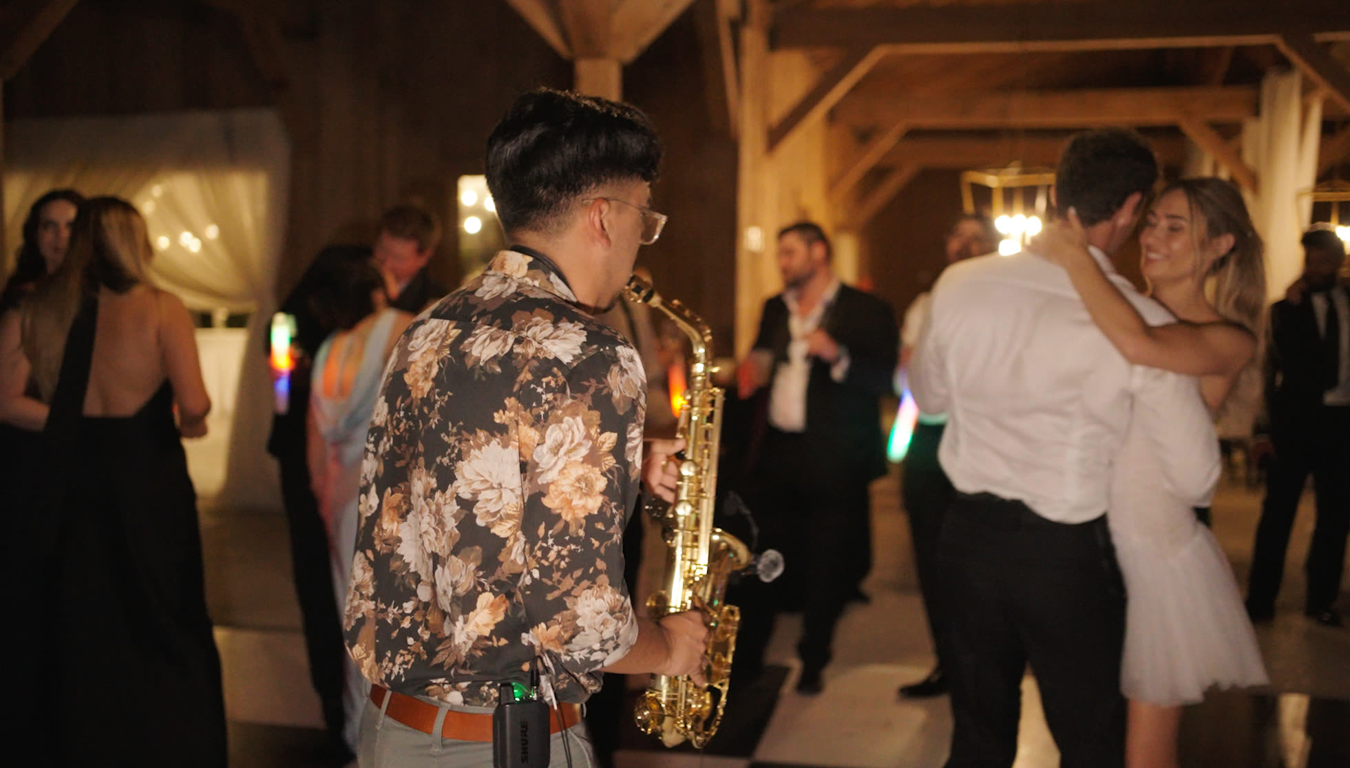 Bride and groom dancing with live saxophone at a reception